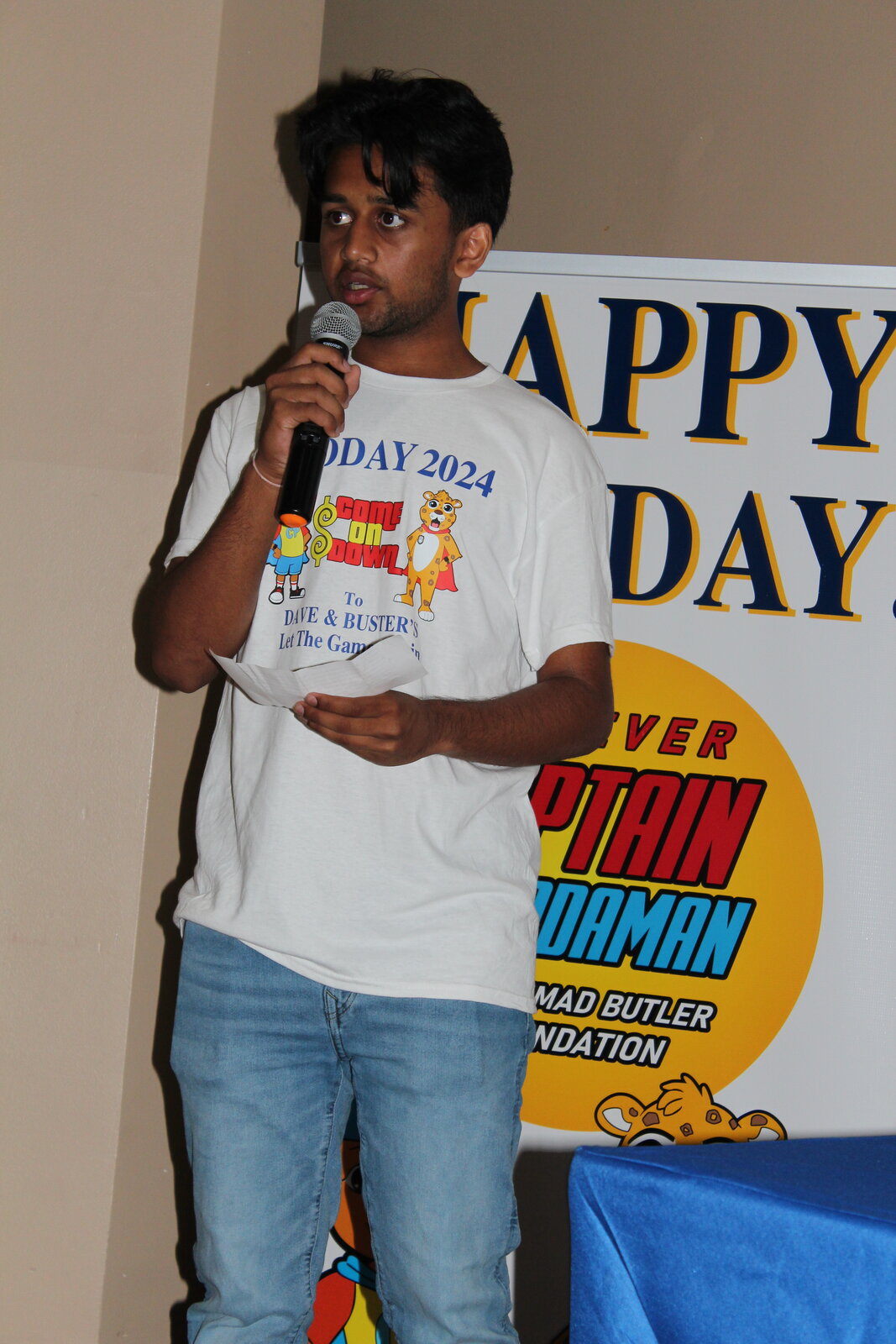 Abhi speaking into a microphone at POO Day 2024