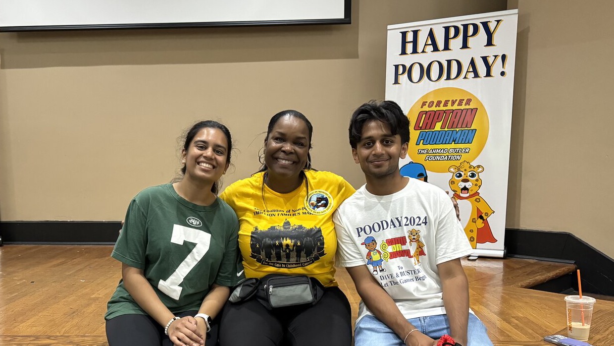 Abhi with foundation members in front of the Captain Poodaman banners
