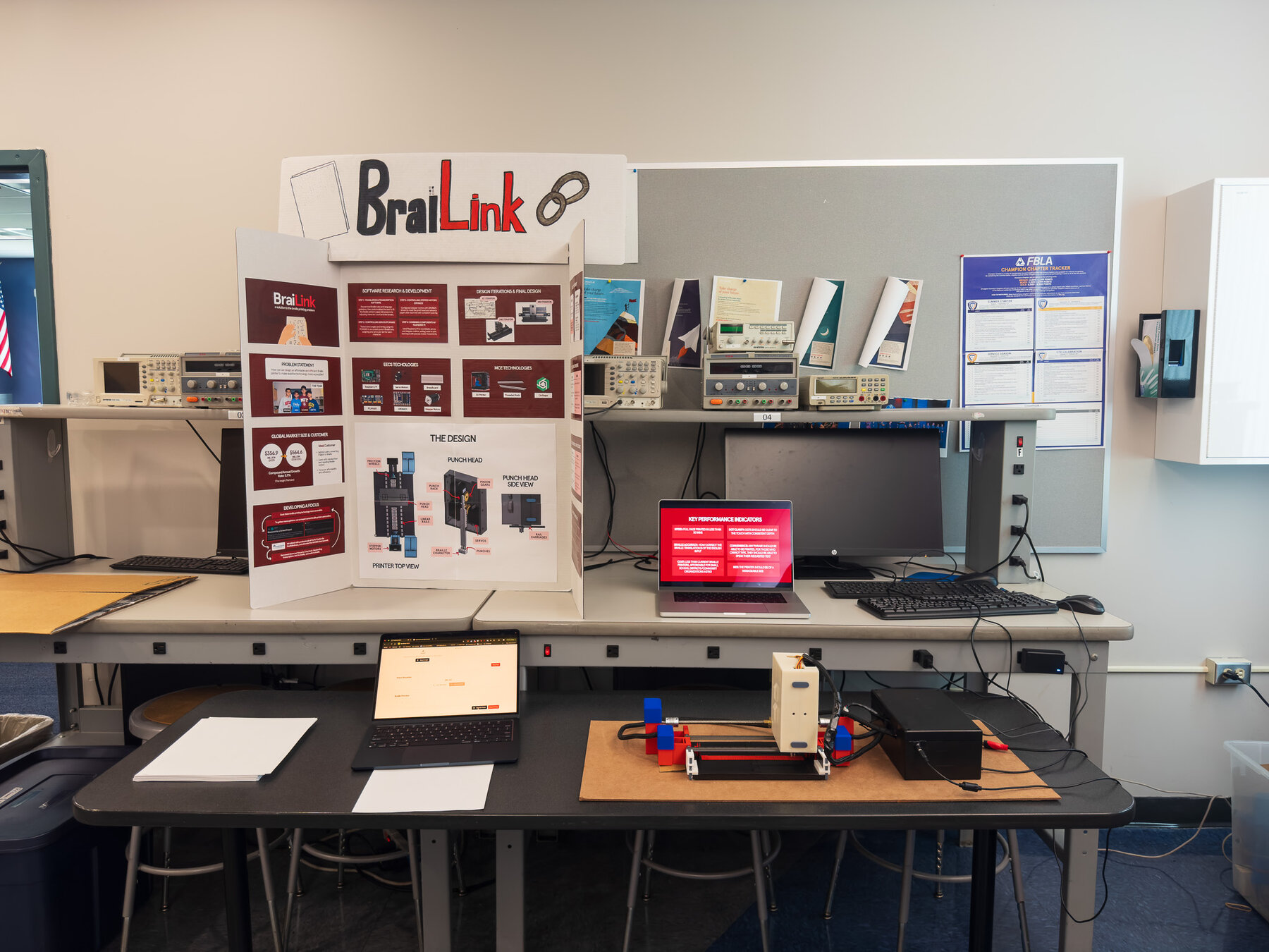 BraiLink expo table with the tri-fold poster and the working prototype