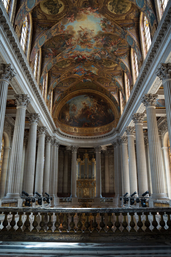 A palace chapel interior with columns and a painted ceiling